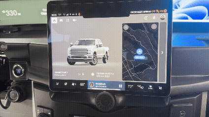 Truck interior with center console infotainment display showing full screen navigation and media controls