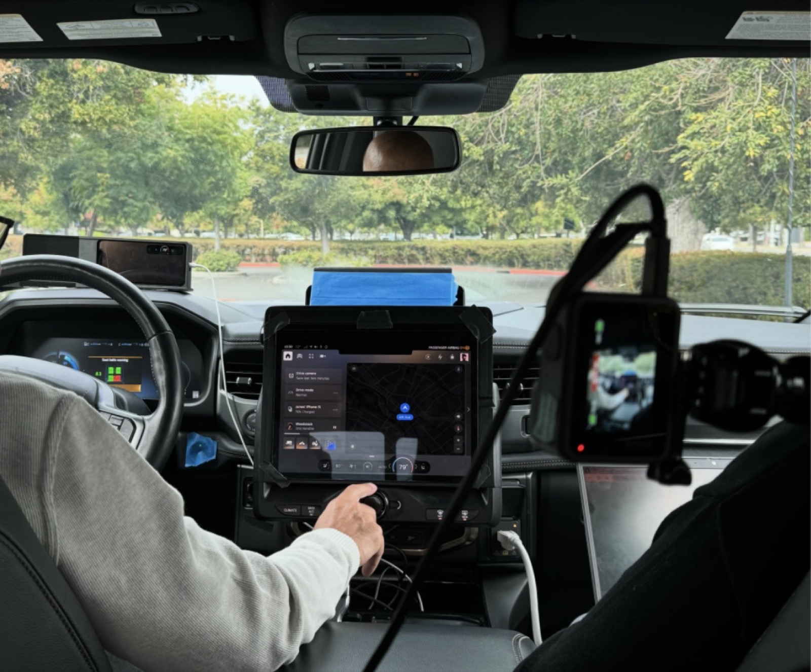 User testing session: researcher observing driver interaction with the in-vehicle prototype